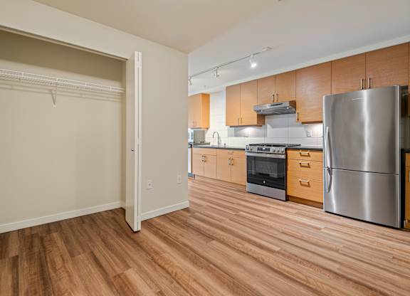 Kitchen with stainless steel appliances and wood floors at Axis Seattle Apartments, Washington, 98109