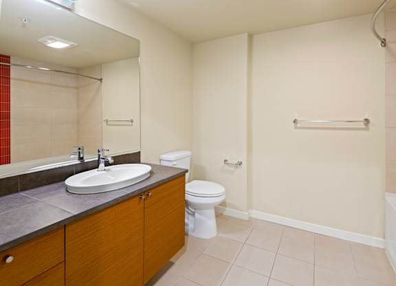 Spacious bathroom with tub and modern vanity at Axis Seattle Apartments, Washington