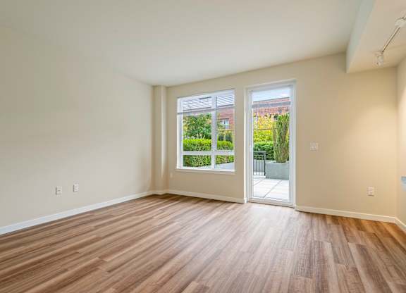 Spacious living room with patio access at Axis Seattle Apartments, Seattle, WA 98109