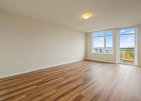 Bright empty room with laminate flooring and windows at Axis Seattle Apartments, Seattle