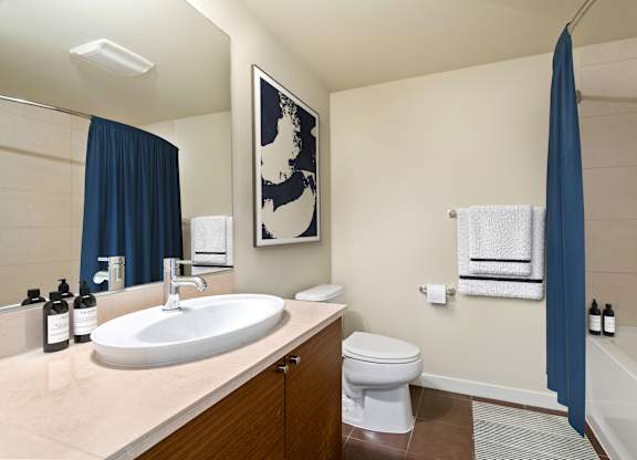 Clean bathroom with tub shower combo at Axis Seattle Apartments, Seattle, Washington