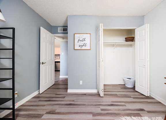 A room with a wooden floor and a white door.