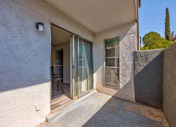A patio area with a glass door