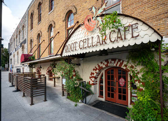 A brick building with a sign that says Root Cellar Cafe.