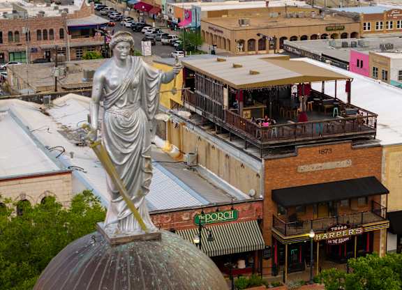 A statue of a woman holding a torch in San Marcos Texas