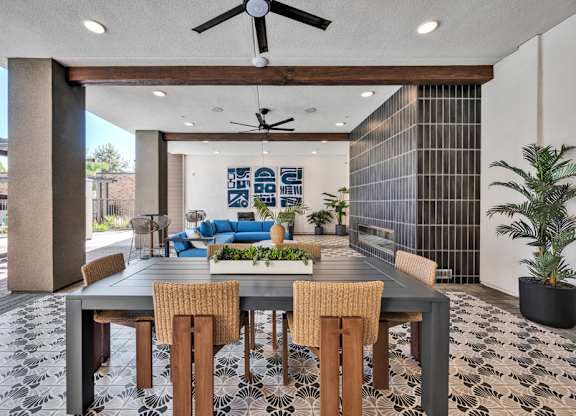 A dining room with a table and chairs.