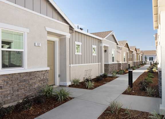 A row of houses numbered from 1102 to 1112.