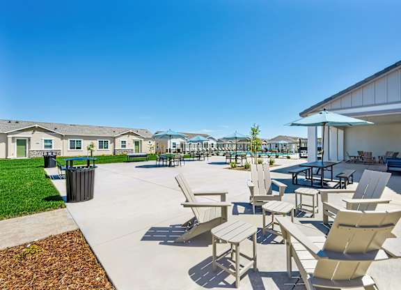 A sunny day at the outdoor seating area of a residential complex.