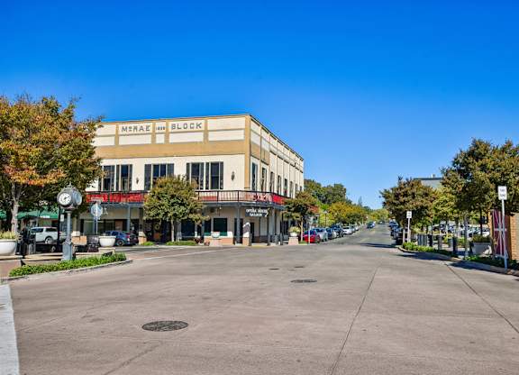 A street view of a city with a building named