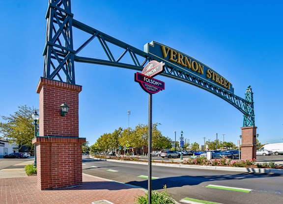 A street sign for Vernon Street is displayed on a metal archway.