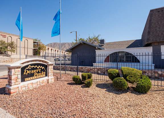 A sign that says Desert Peaks Apartments