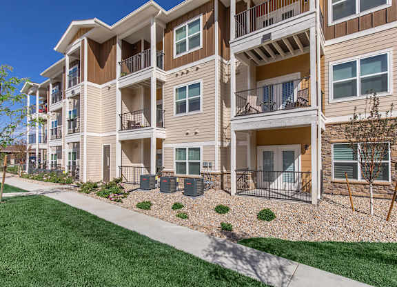 Apartment building with a green lawn in front.