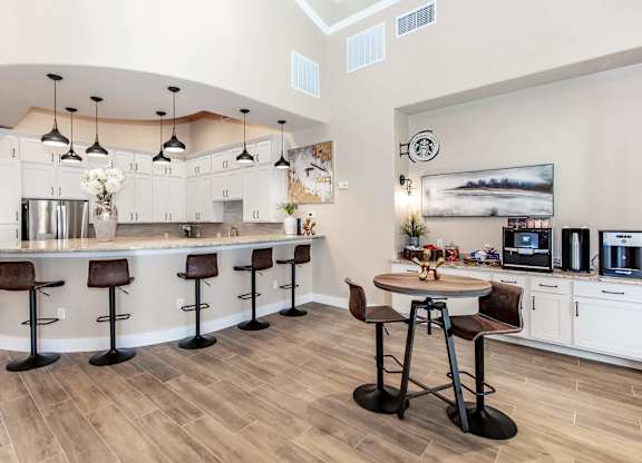 A kitchen with a bar area and a dining table.