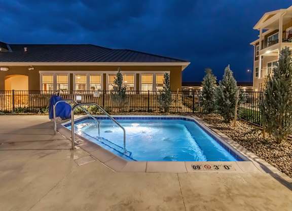 A residential building with a pool in the backyard.