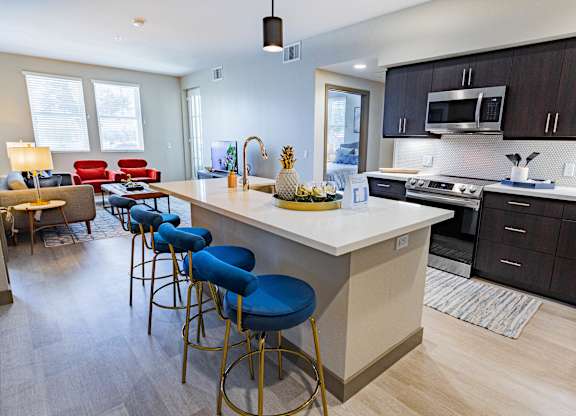 furnished kitchen with stool seating at Bayswater Apartments, California