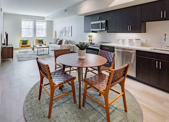 Eat-In Kitchen With Dining Room Table, Black Cabinets, White Countertops, And Stainless-Steel Appliances. at Bayswater Apartments, Burlingame, 94010