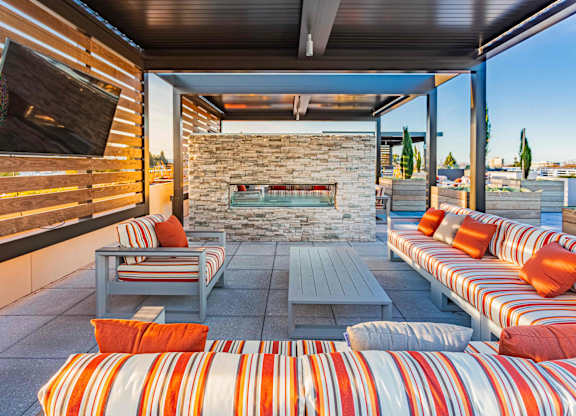 Rooftop lounge seating with TV and fireplace at Bayswater Apartments, California