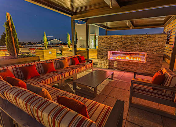 Expansive Rooftop Outdoor Fireplace And Grilling Area With Couches, Chairs, And Panoramic Views at Bayswater Apartments, Burlingame, 94010