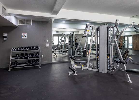 A gym with a variety of equipment including weights and machines at Verandas Apartments, West Covina, CA, 91791