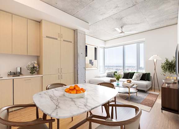 A modern kitchen with a marble table and chairs.