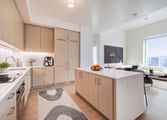 A modern kitchen with wooden cabinets and a white island.