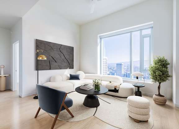 A modern living room with a large window overlooking the city.