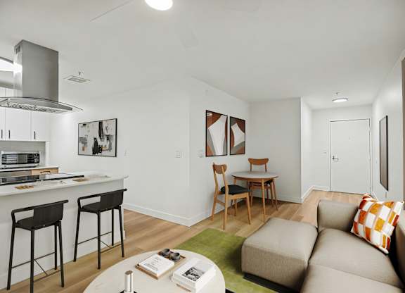 A modern kitchen with a bar area and a living room area.