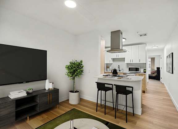 A modern kitchen with a black countertop and white cabinets.