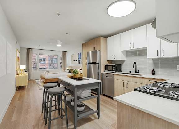A kitchen with a table and chairs in front of a window.