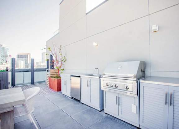 A white outdoor kitchen with a grill and sink.at The Rise, San Francisco, 94103  