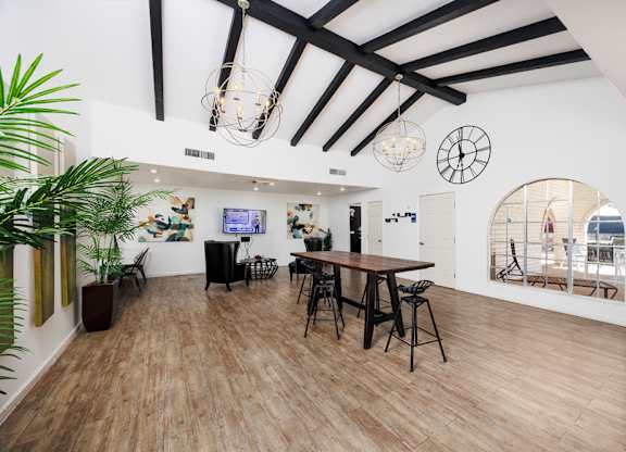 A room with wooden floors and a large mirror on the wall.