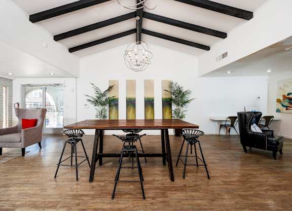 A dining room with a wooden table and chairs.