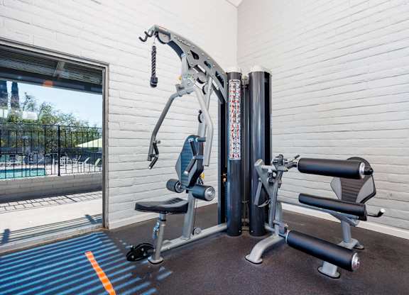 A gym machine is in front of a window.