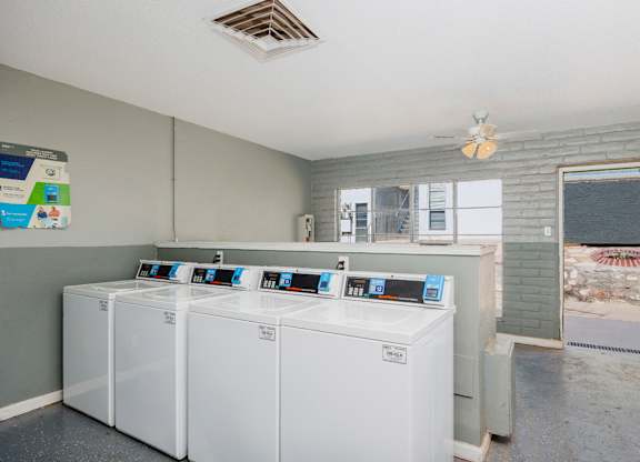 A laundry room with washers and dryers.