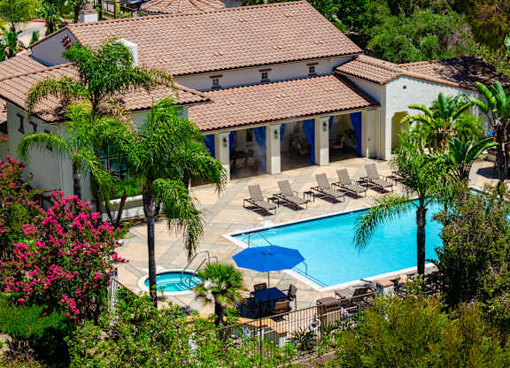 A house with a pool and patio furniture.