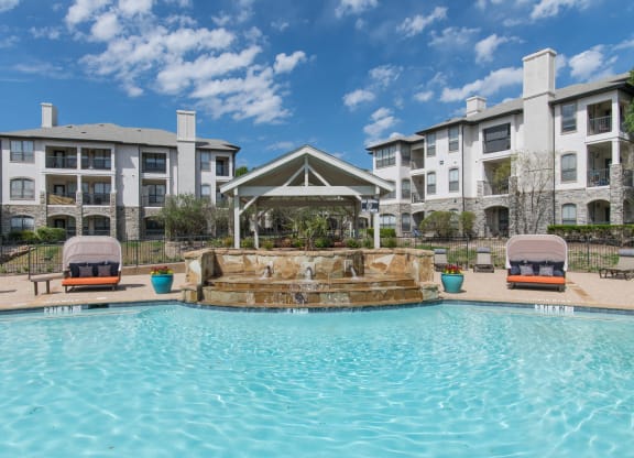 Large swimming pool with a waterfall at Silverado, Frisco, Texas