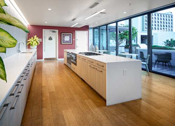 A kitchen with wooden floors and white countertops.