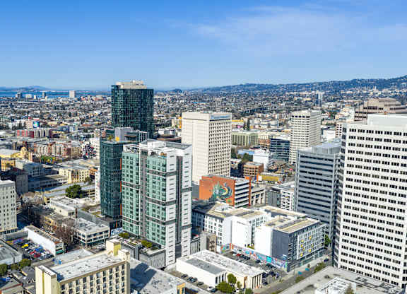 A cityscape with various buildings and a clear sky.