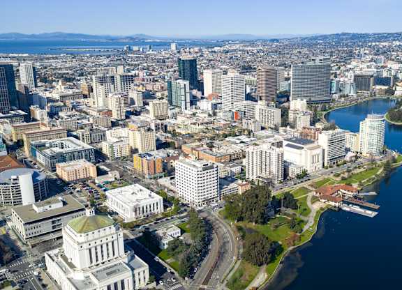 A cityscape with a large body of water in the foreground.