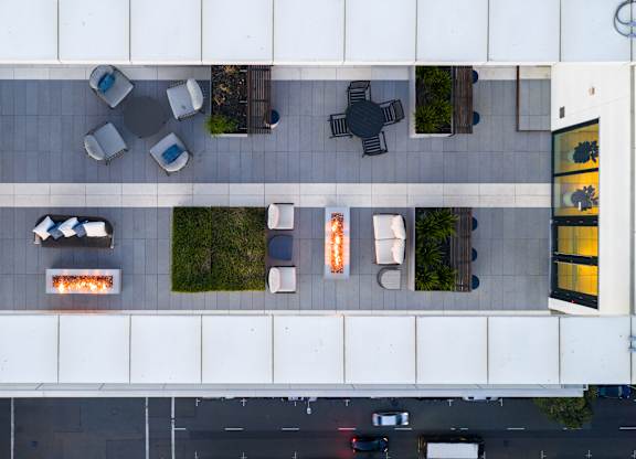 A parking lot with cars and a building with a fireplace.