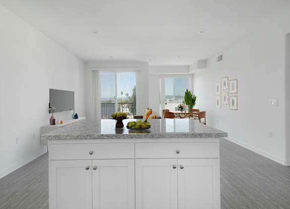 A kitchen with white cabinets and a marble countertop.at 422 South Lake, Los Angeles  