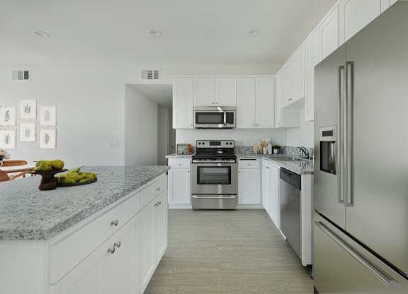 A modern kitchen with stainless steel appliances and white cabinets.at 422 South Lake, Los Angeles, CA  