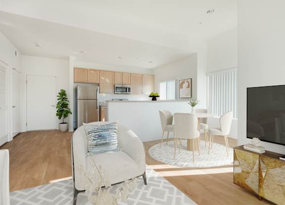 A modern living room with a white sofa and a television.at Grand View Towers, Los Angeles, 90057  