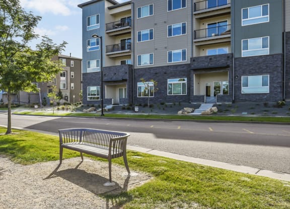 a park bench sitting on the side of a street at Parkside at Littleton Village, Littleton