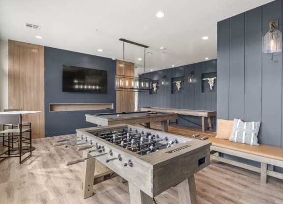 a game room with a foosball table and a tv at Parkside at Littleton Village, Littleton, Colorado