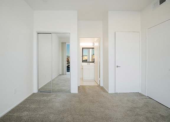 A hallway with a carpeted floor and white walls.at Plaza Lafayette, California  