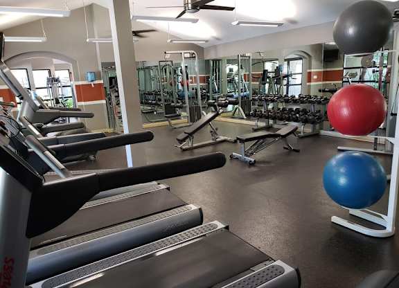 A gym with treadmills, dumbbells, and exercise balls.at Solterra At Civic Center, Norwalk, CA  