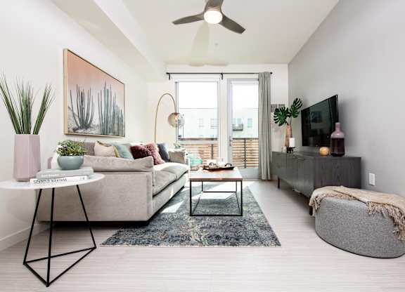 Living room with large doors and ceiling fan