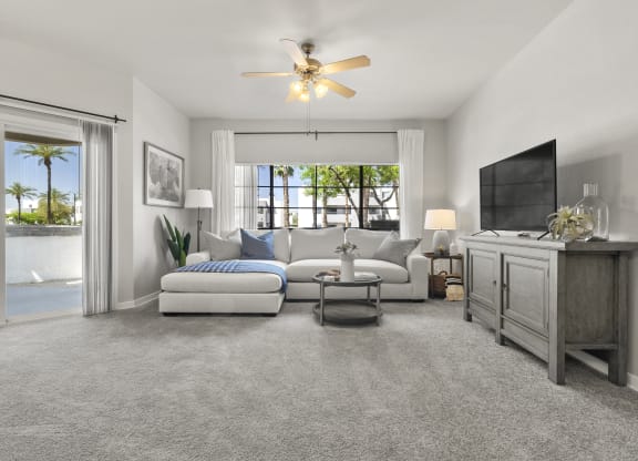 a living room with a couch and a tv at Vaseo Apartments, Phoenix Arizona