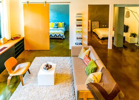 A living room with a couch, chair, and a coffee table.